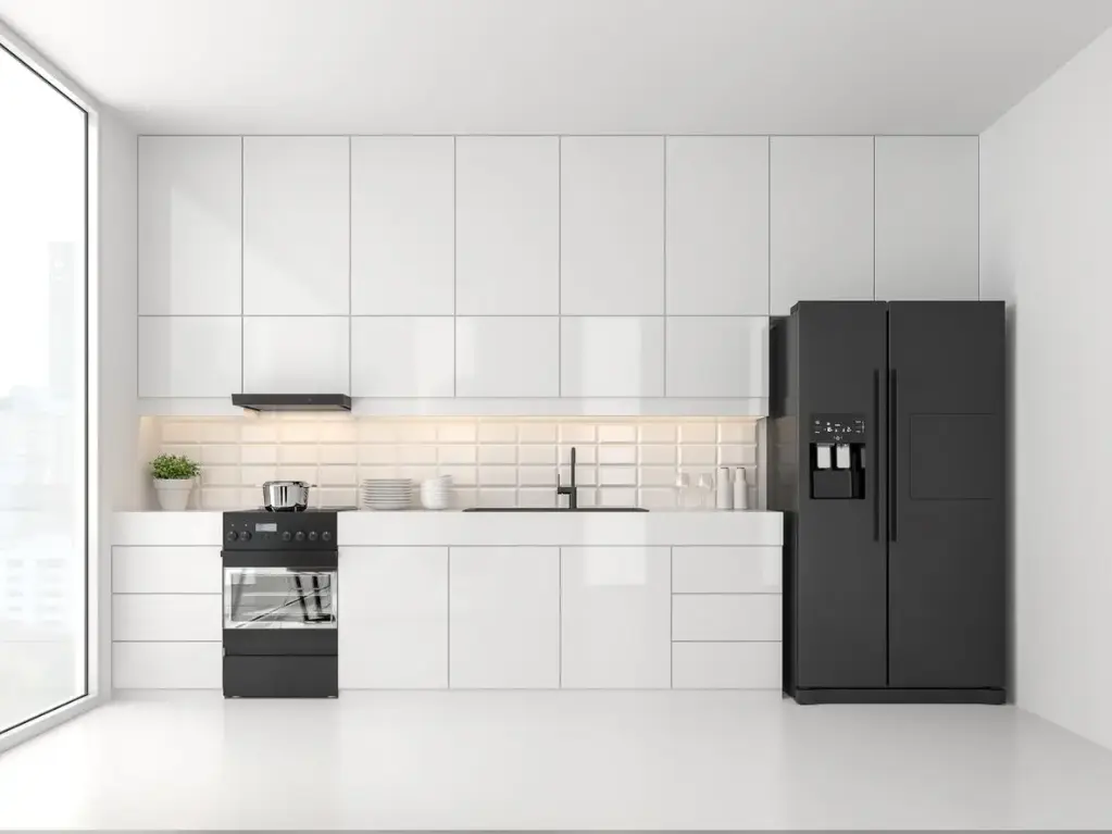 Cuisine en I – Finition blanche brillante, avec un plan de travail en quartz.