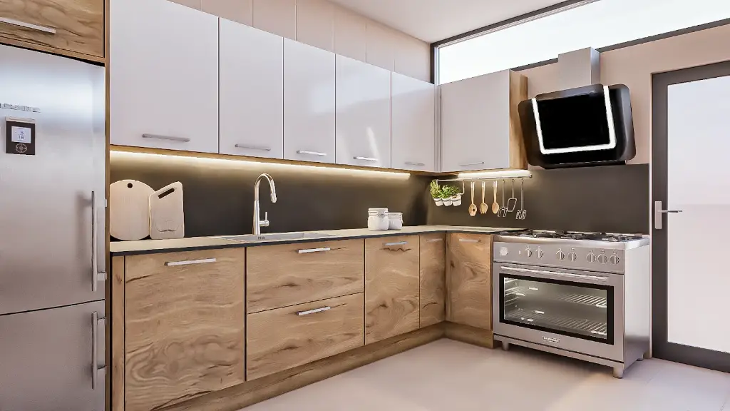 Cuisine en L – En teck, avec un plan de travail en granit.