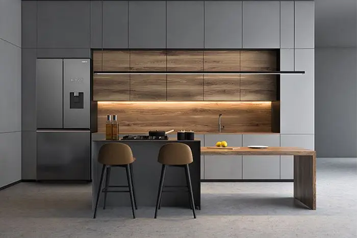 Cuisine avec îlot central – En gris Ombre, avec un plan de travail en granit.