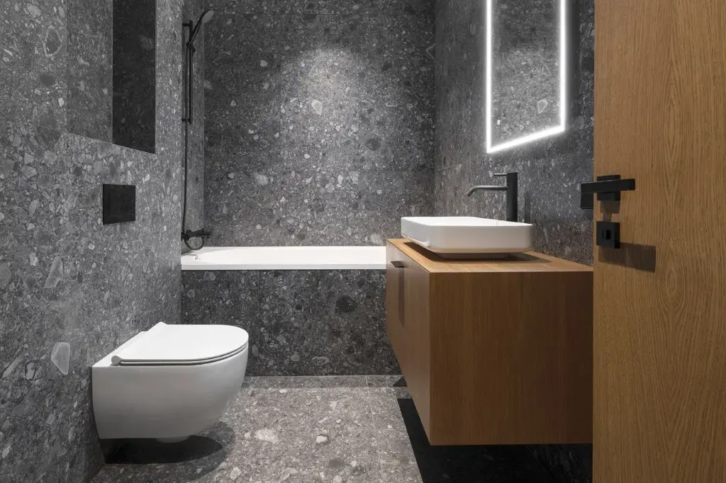 Salle de bain luxueuse avec revêtement en pierre grise et éclairage LED