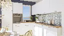 Cuisine en L – Finition blanche mate, avec un plan de travail en bois massif.