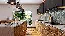 Cuisine avec îlot central – En teck, avec un plan de travail en quartz.