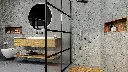Salle de bain industrielle avec murs en béton et verrière noire
